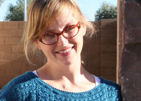 Andrea_candid_headshot_in_blue_sweater_show