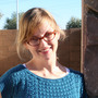 Andrea_candid_headshot_in_blue_sweater_large