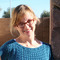 Andrea_candid_headshot_in_blue_sweater_thumb