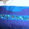 Blue_and_purple_striped_pleated_handbag_close_up_grid