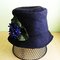 Black_wool_felt_cloche_with_cluster_of_purple_violets_01_grid
