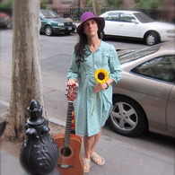 Cathy_with_flower_and_guitar_listing