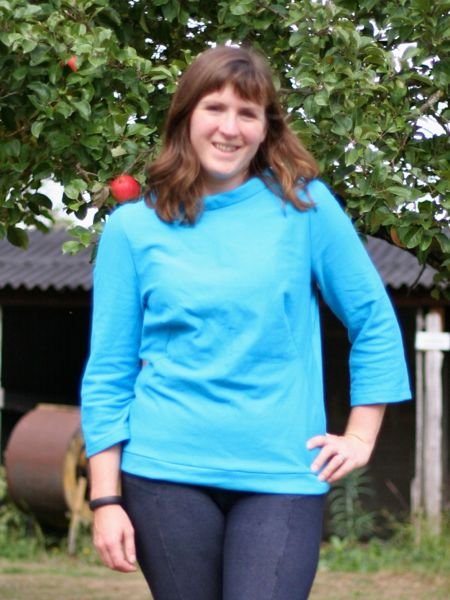 Turquoise_sweatshirt_-_hand_on_hip_smiling_large